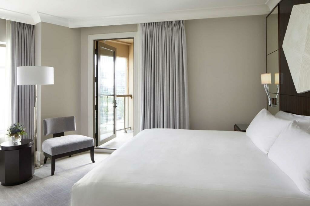 A bedroom with a balcony at the Waldorf Astoria Atlanta Buckhead.